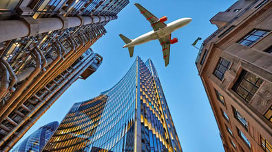 Aeroplane from below with skyscrapers