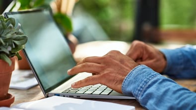 Person typing on a laptop