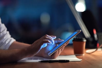 Image of a person using a tablet at a work station