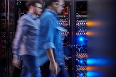 Image of two people in conversation in a server room