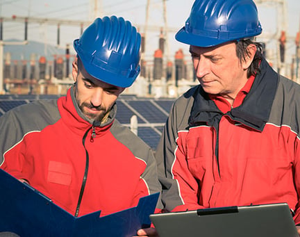 Two engineers in front of solar panels