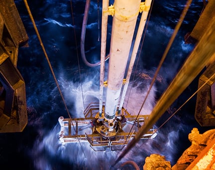 Drilling rig going down into the sea