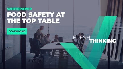 Business leaders gathered around a conference table, promoting a whitepaper on innovative food safety strategies titled 'Food Safety at the Top Table