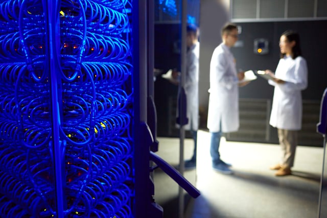 Engineers in background of a server room