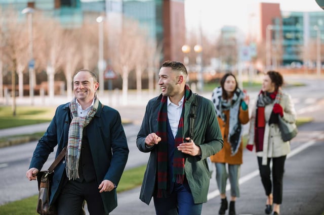 Group of males and females talking and walking in the cold
